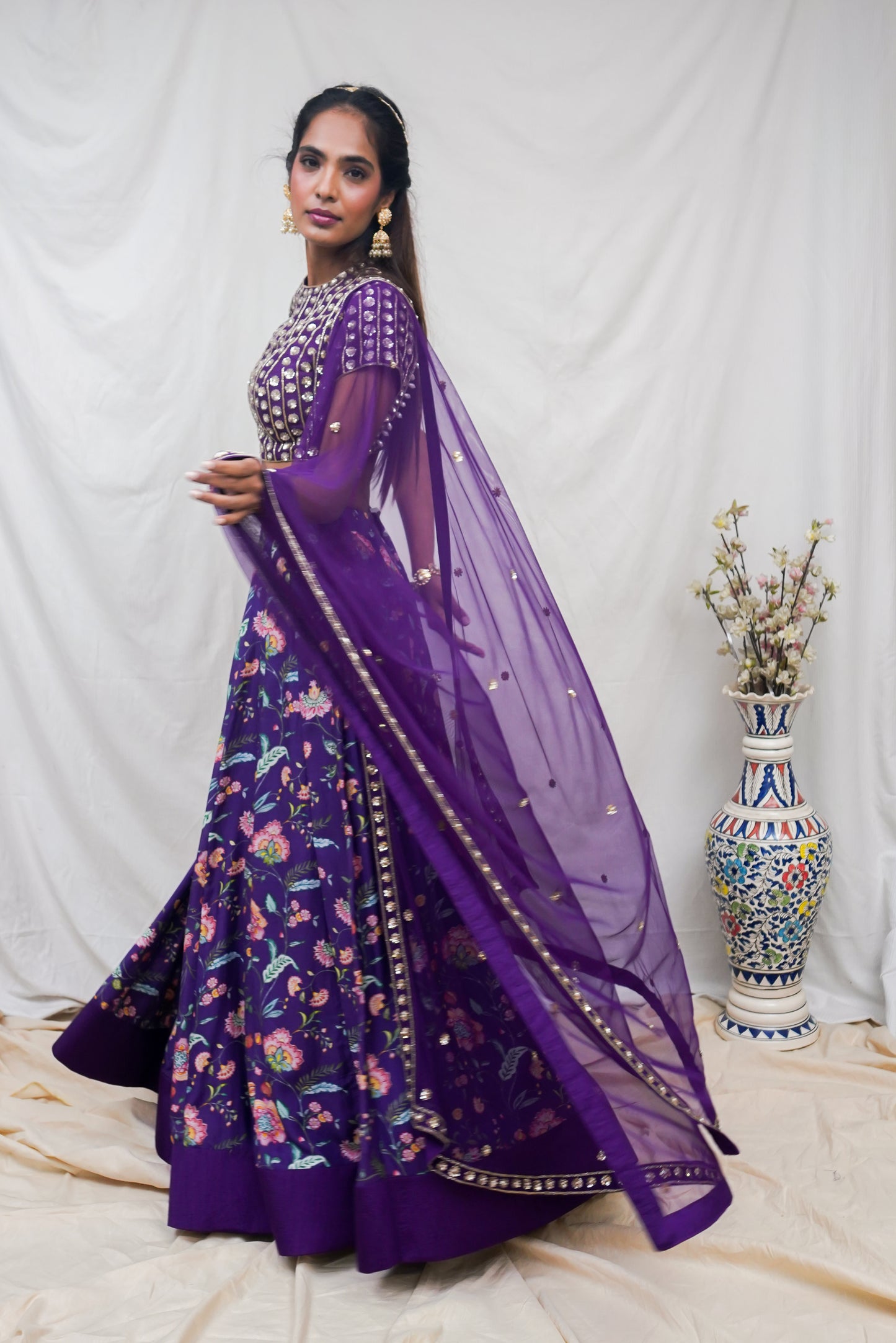 Deep purple hand embroidered blouse and dupatta with a high waisted floral printed lehenga