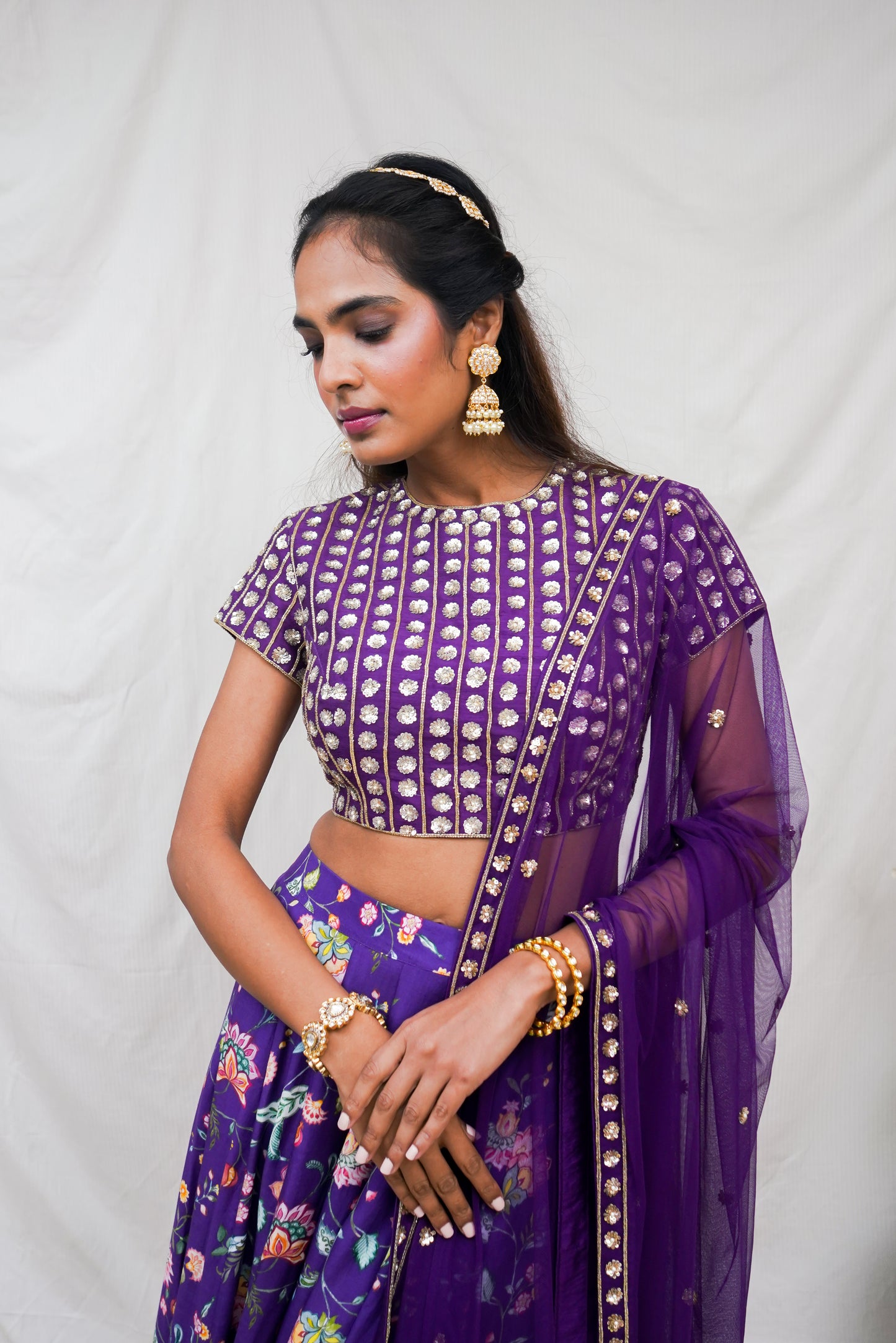 Deep purple hand embroidered blouse and dupatta with a high waisted floral printed lehenga