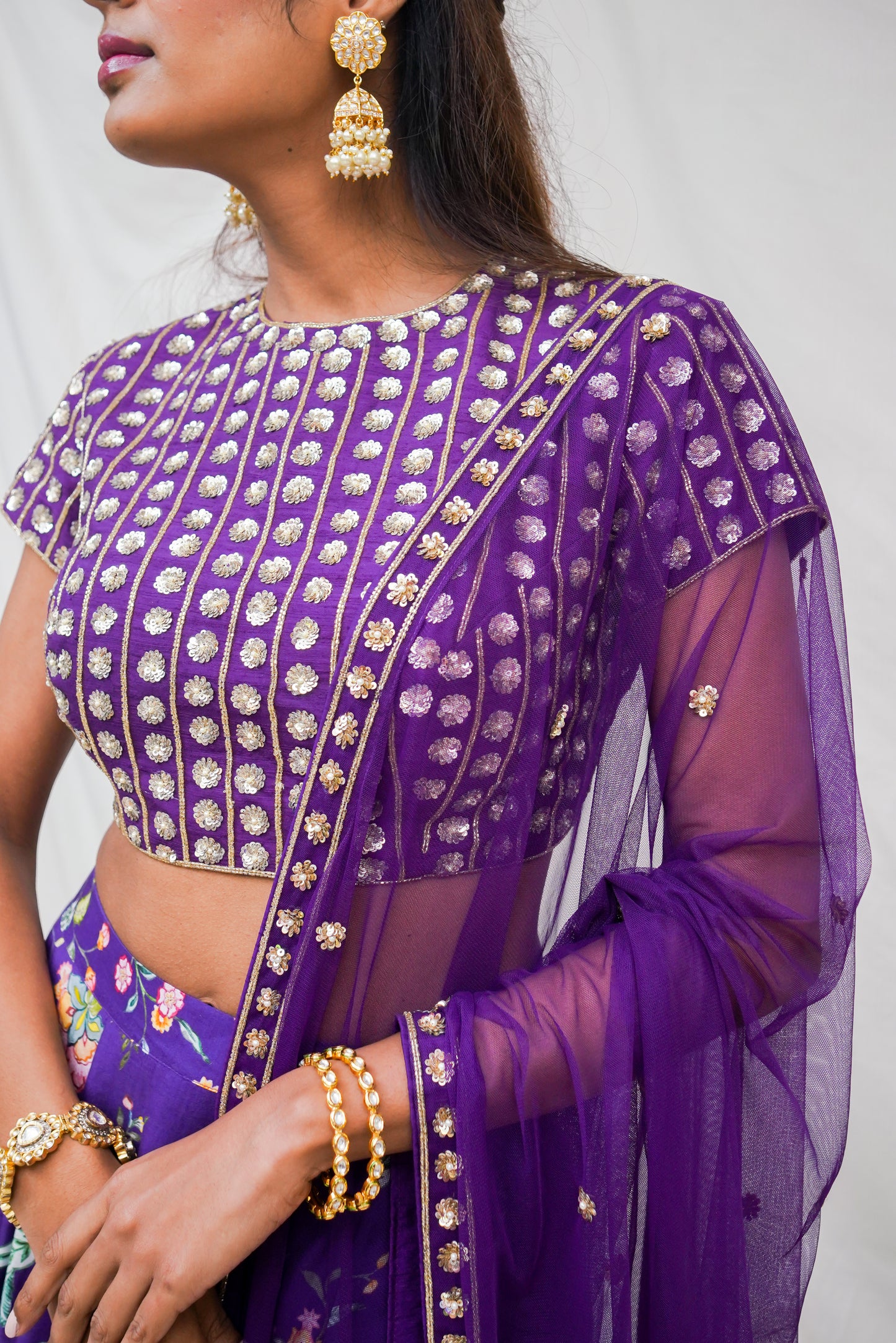 Deep purple hand embroidered blouse and dupatta with a high waisted floral printed lehenga