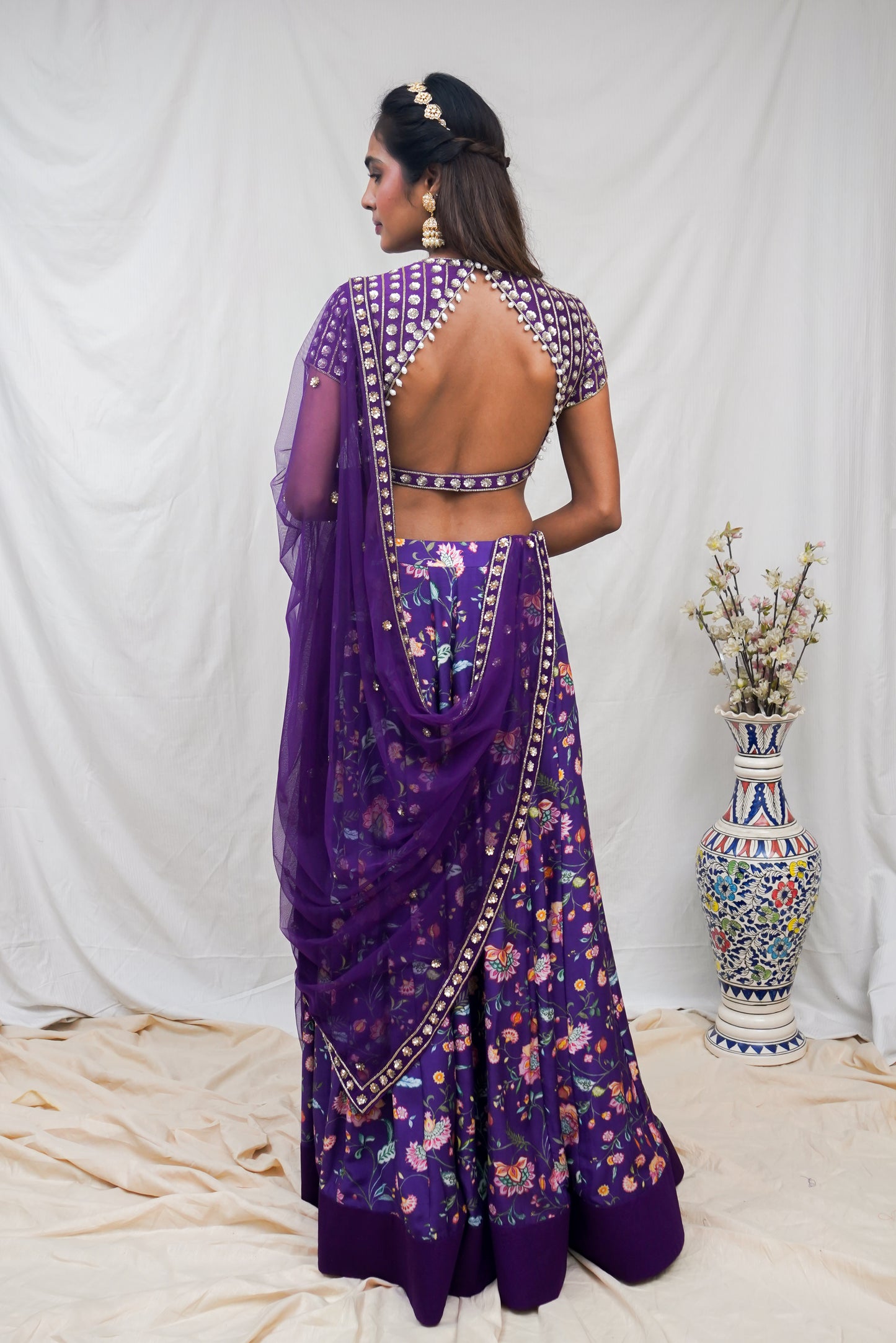 Deep purple hand embroidered blouse and dupatta with a high waisted floral printed lehenga