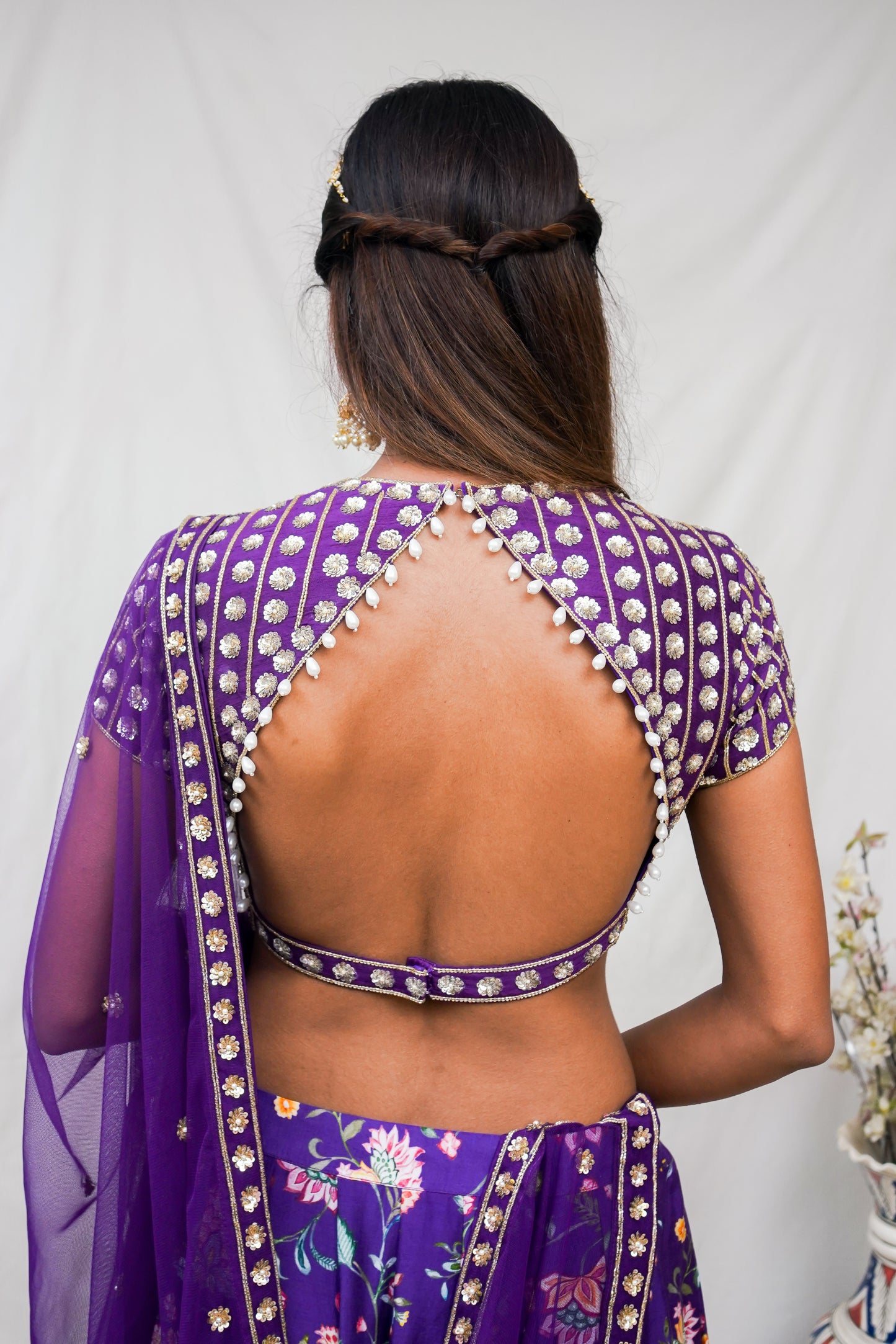 Deep purple hand embroidered blouse and dupatta with a high waisted floral printed lehenga