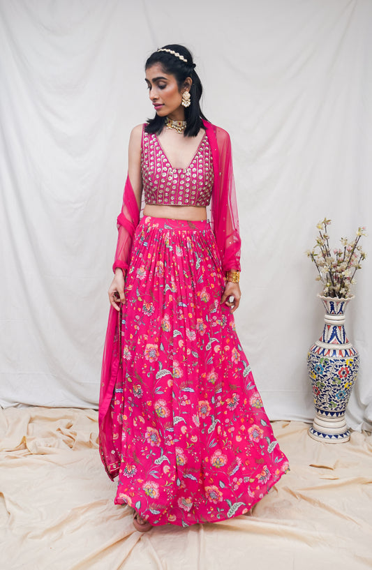 Rani pink hand embroidered blouse and dupatta with a high waisted floral printed lehenga