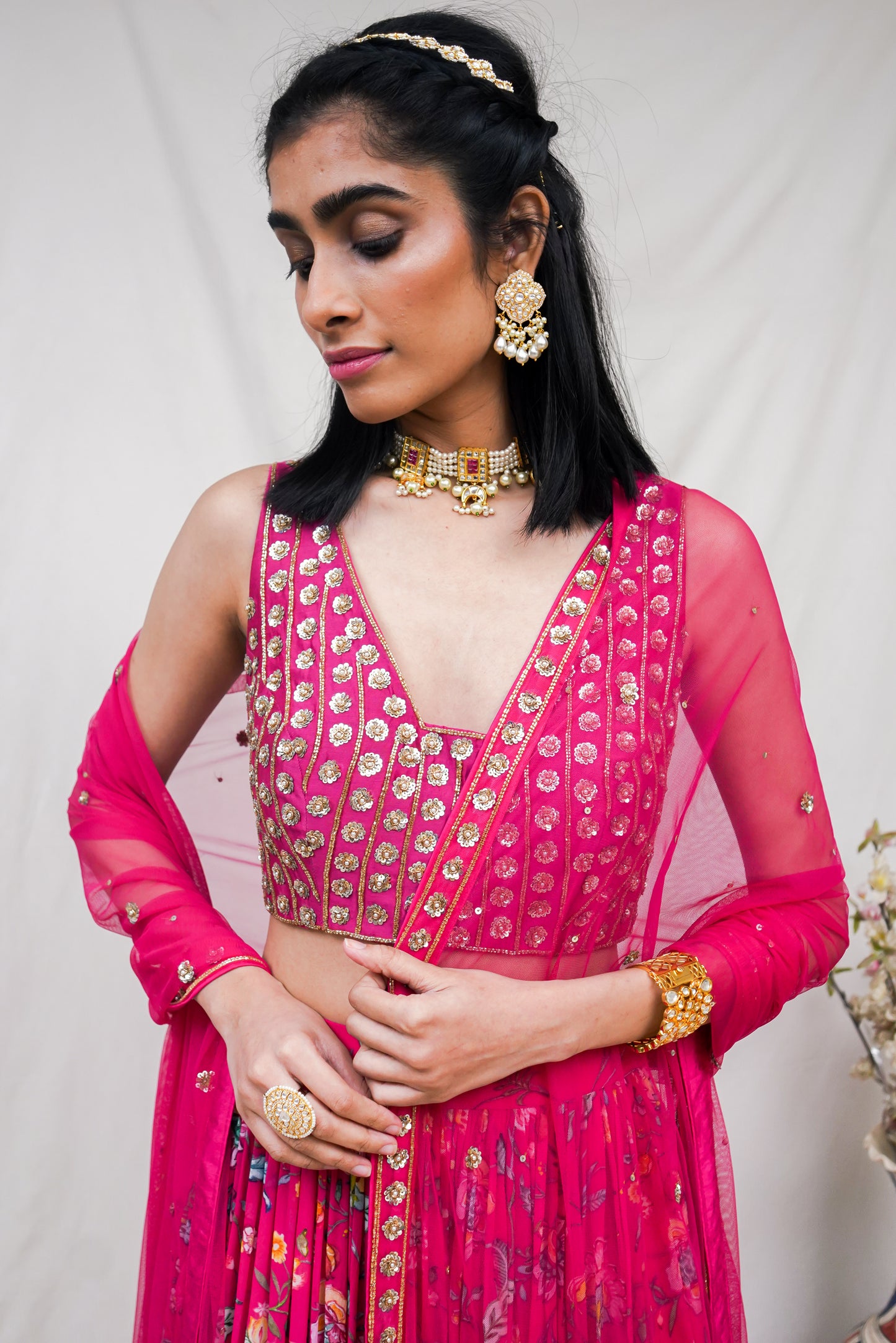 Rani pink hand embroidered blouse and dupatta with a high waisted floral printed lehenga