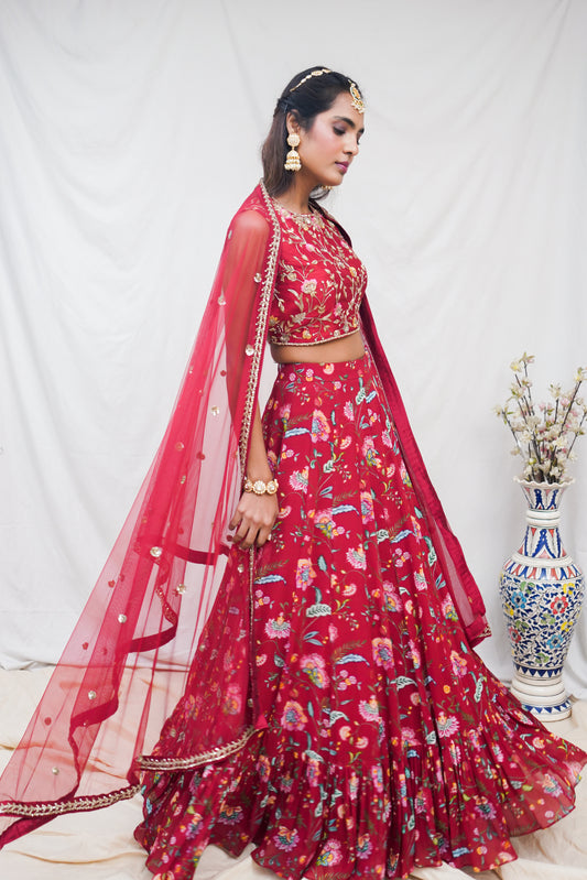 Hand embroidered red sleeveless blouse and dupatta with a high waisted floral printed lehenga