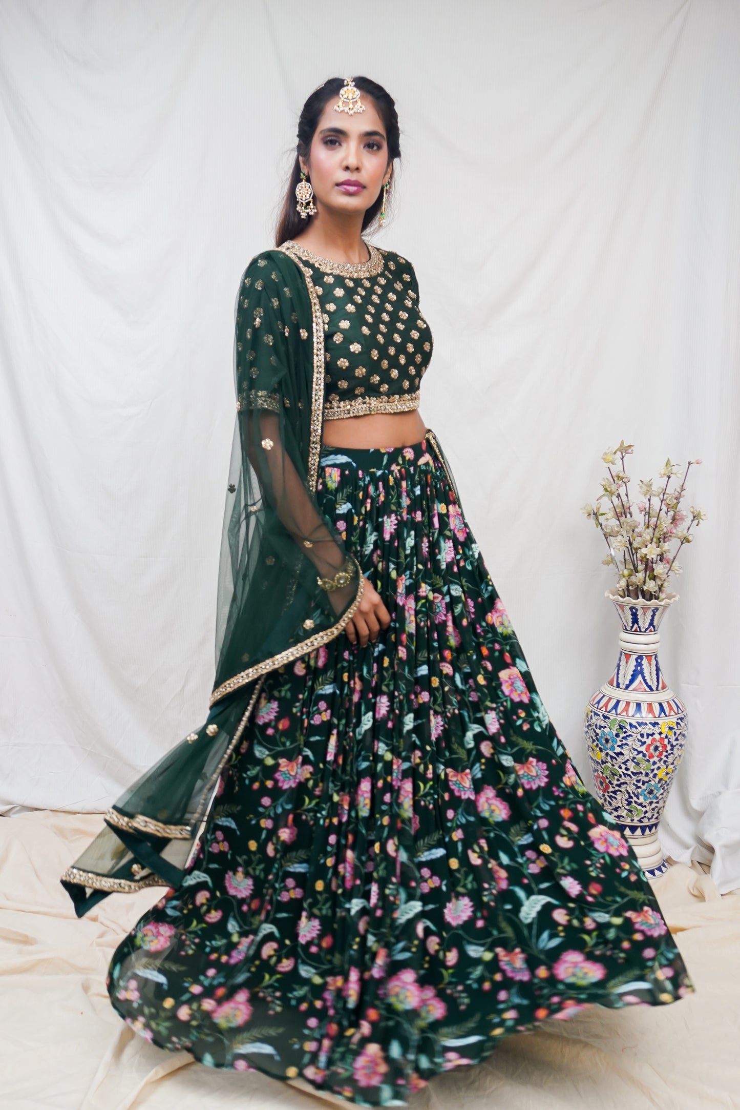 Bottle green hand embroidered blouse and dupatta with a high waisted floral printed lehenga