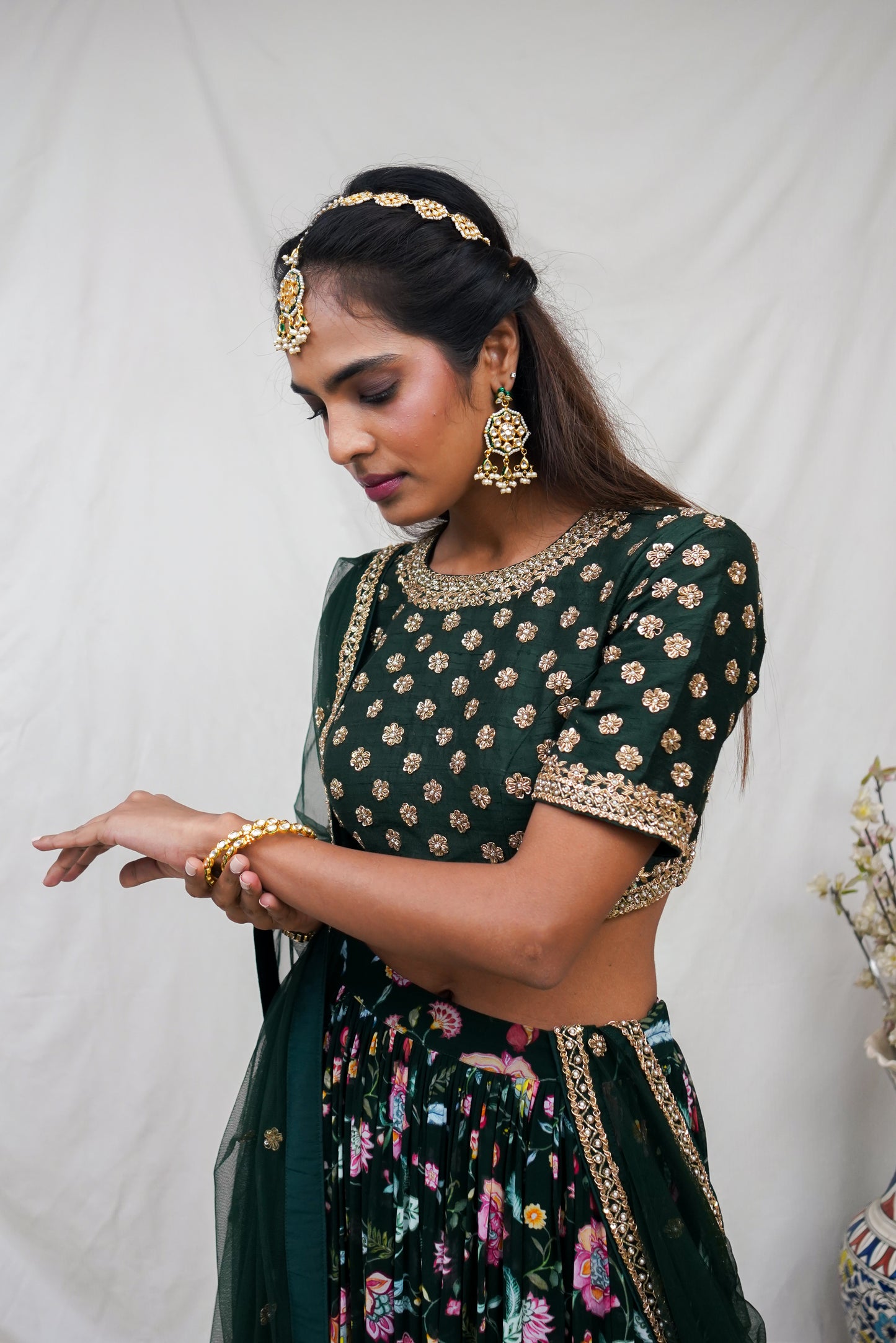 Bottle green hand embroidered blouse and dupatta with a high waisted floral printed lehenga