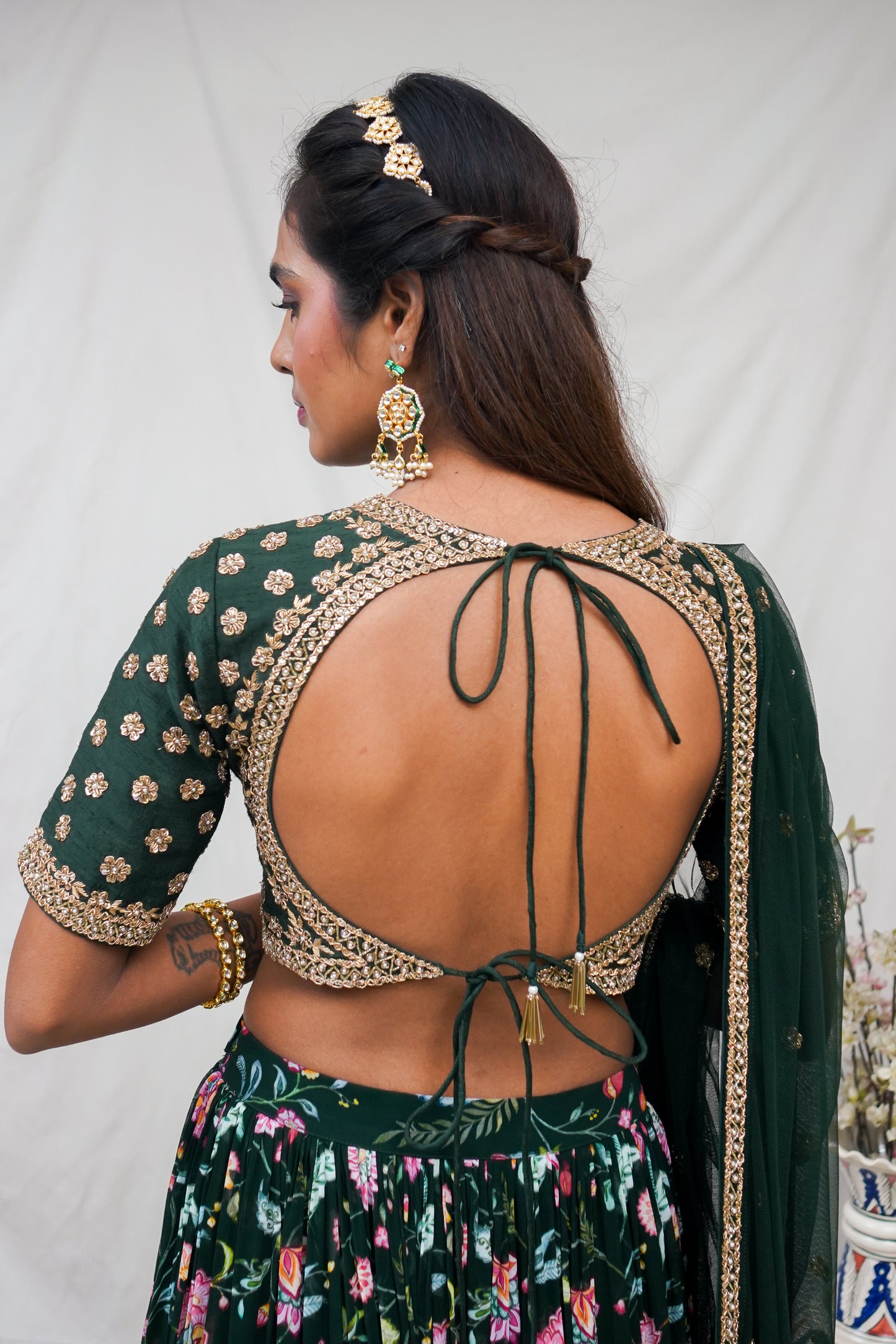 Bottle green hand embroidered blouse and dupatta with a high waisted floral printed lehenga