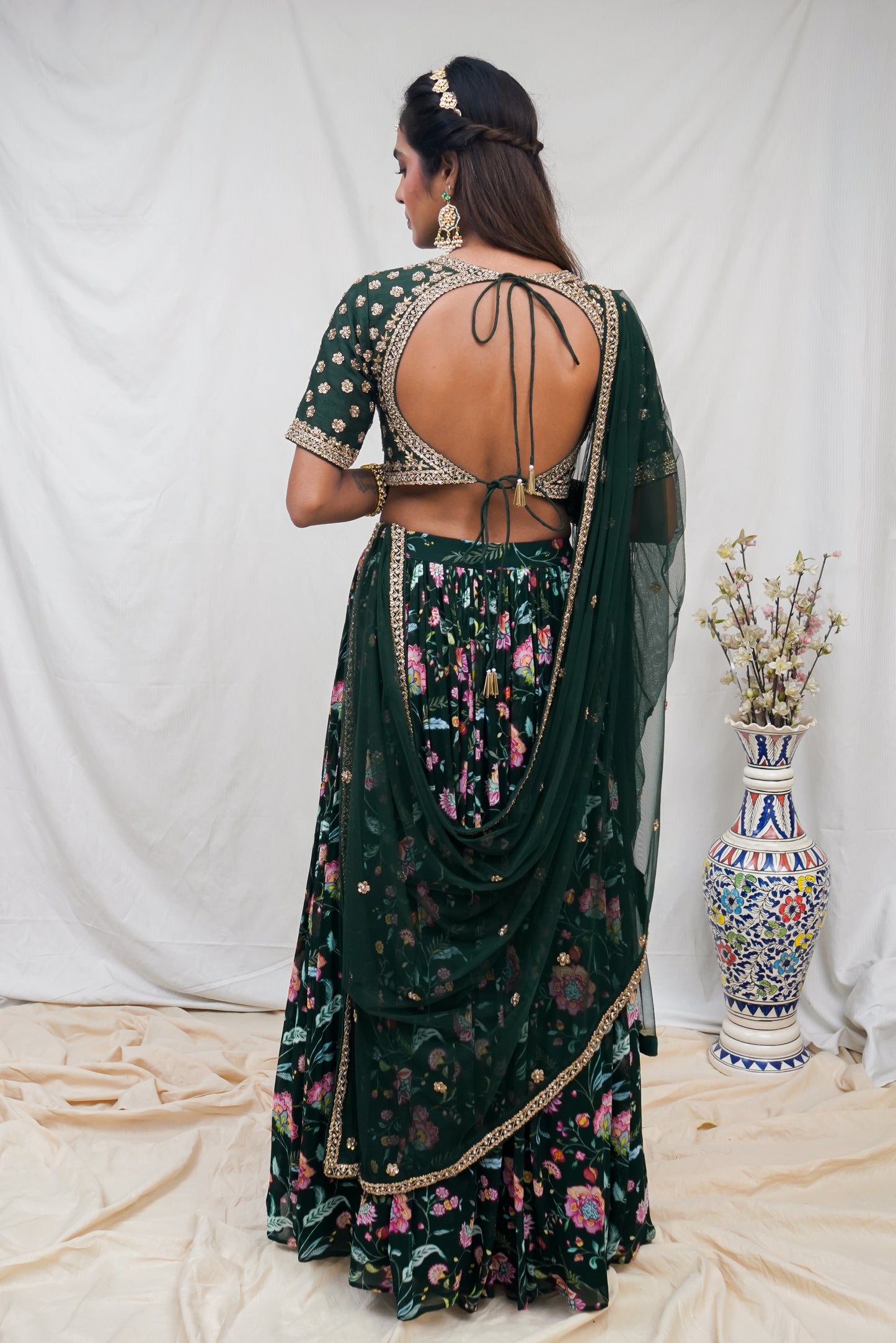 Bottle green hand embroidered blouse and dupatta with a high waisted floral printed lehenga