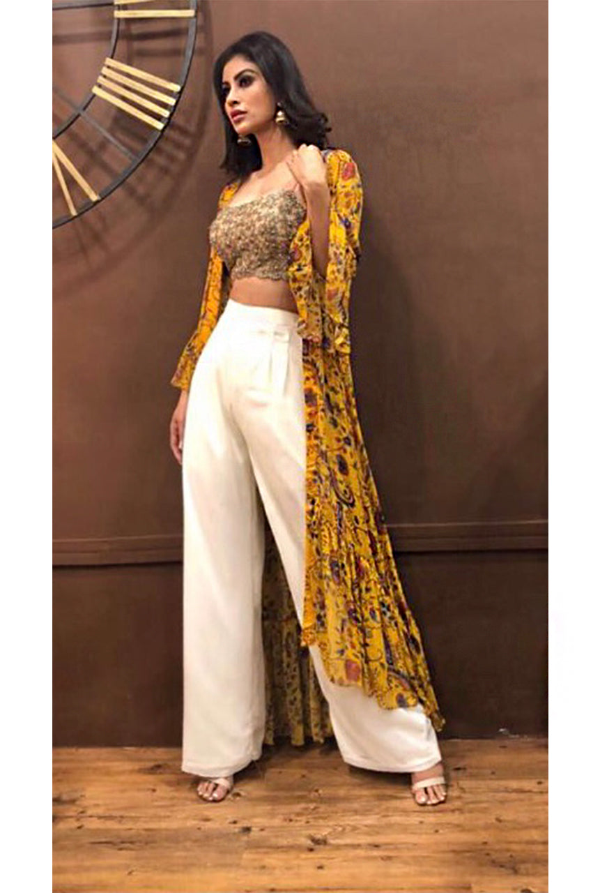 Mouni Roy : Hand embroidered gold blouse with a high waisted pant and yellow floral printed ruffle cape