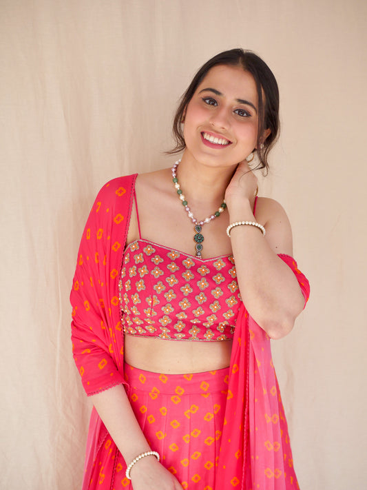 Hot pink hand embroidered blouse with a high waisted floral printed lehenga and dupatta