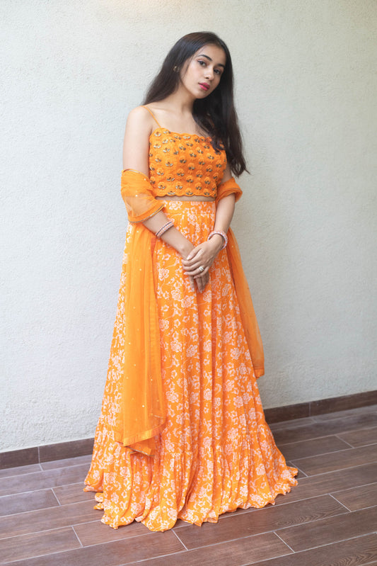 Sunshine orange floral printed skirt with a self embroidered blouse and dupatta