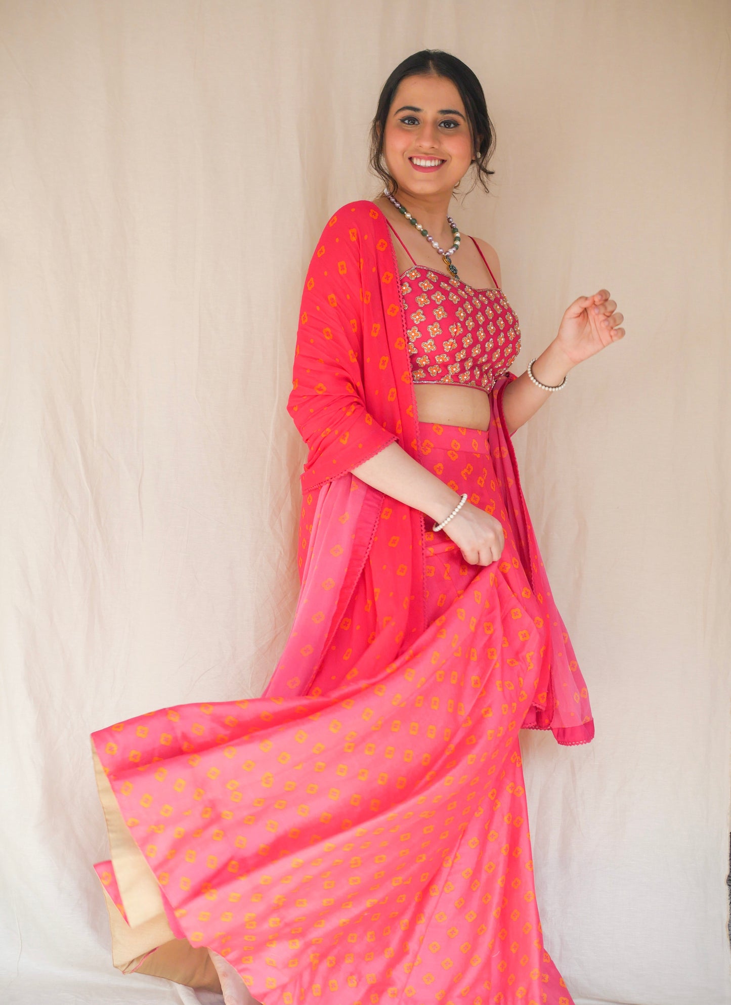 Hot pink hand embroidered blouse with a high waisted floral printed lehenga and dupatta