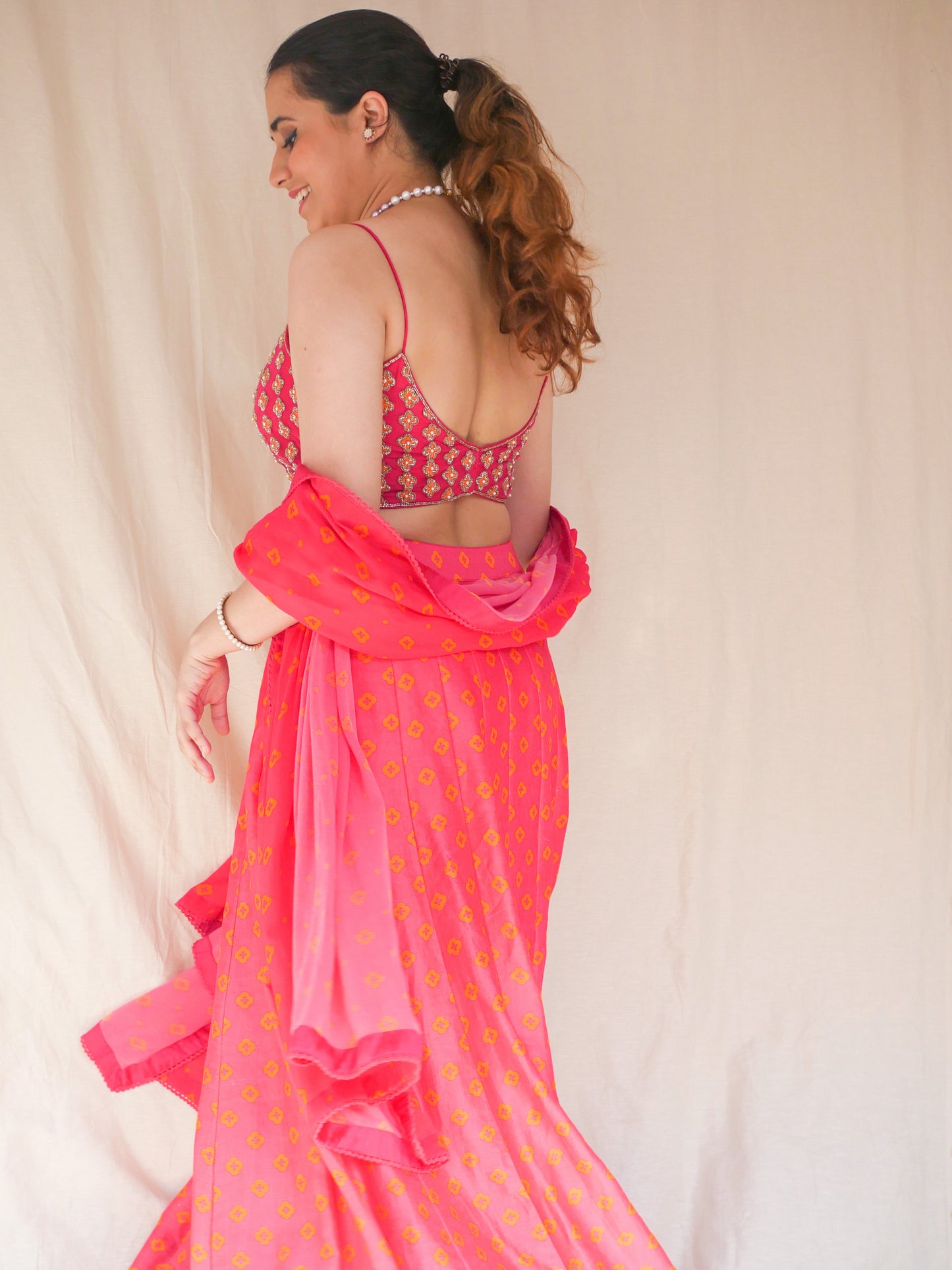 Hot pink hand embroidered blouse with a high waisted floral printed lehenga and dupatta