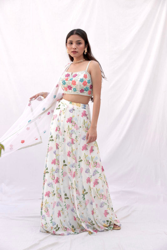 Ivory printed lehenga with a colorful hand embroidered blouse and dupatta