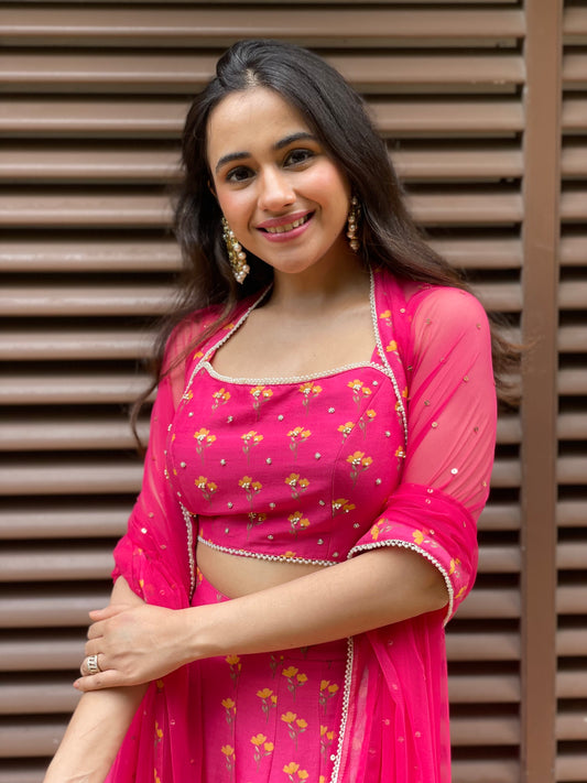 Hot pink floral printed lehenga with an embroidered blouse and dupatta