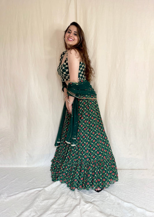 Bottle green floral printed lehenga with a hand embroidered criss cross gold blouse and dupatta