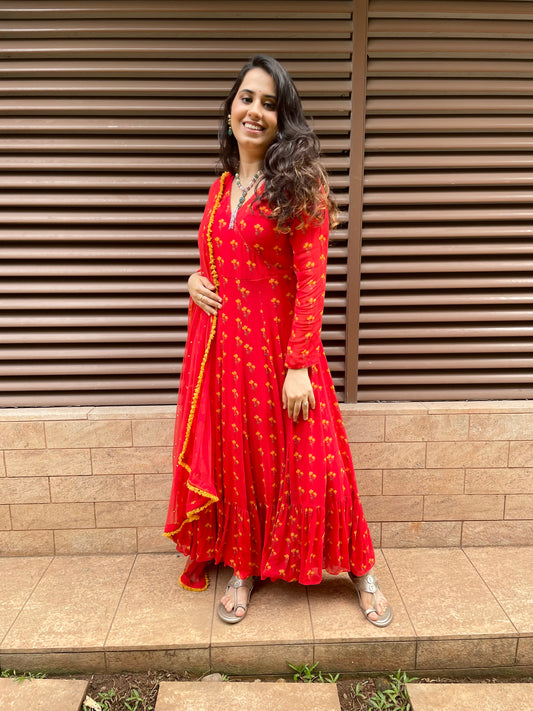 Red floral printed anarkali with an embroidered dupatta and fringe detailing